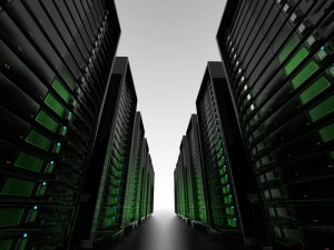 View down a dark server room with faint green lights