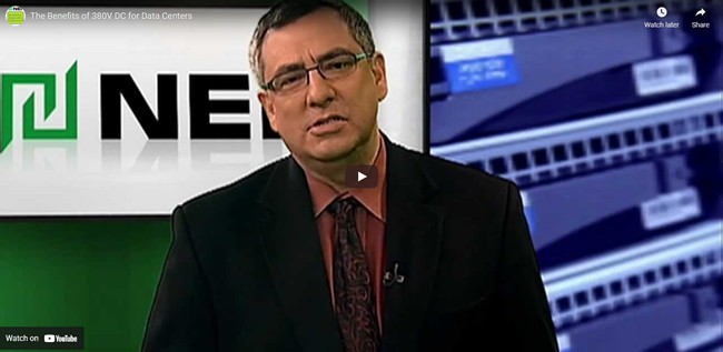 Screenshot of a businessman speaking in front of UNICOM Engineering's logo in YouTube video 'The Benefits of 380V DC for Data Centers'