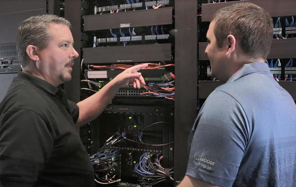 two people looking at a server