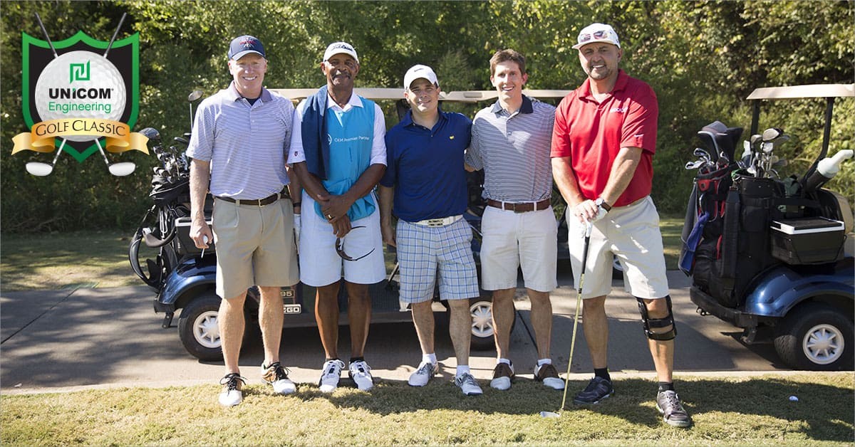 Picture of people at the golf tournament in front of a golfcart 