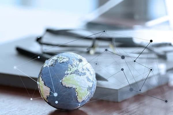 netwrok lines surrounding a globe on a desk