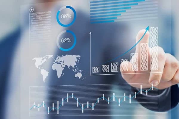 businessman pointing at a screen showing graphical data on a dashboard style layout
