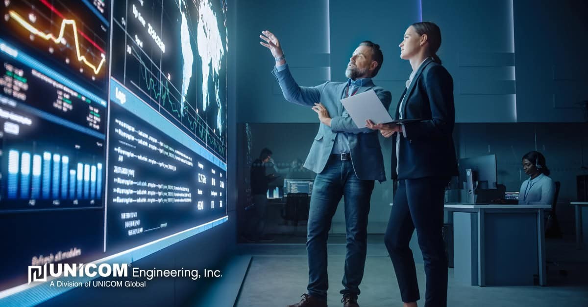 Project Manager and Computer Science Engineer Talk while Using Big Screen Display